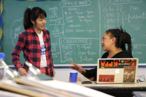 Brooks (right) takes a break from looking at her laptop to chat with a campaign volunteer about her expectations for Tuesday’s race.