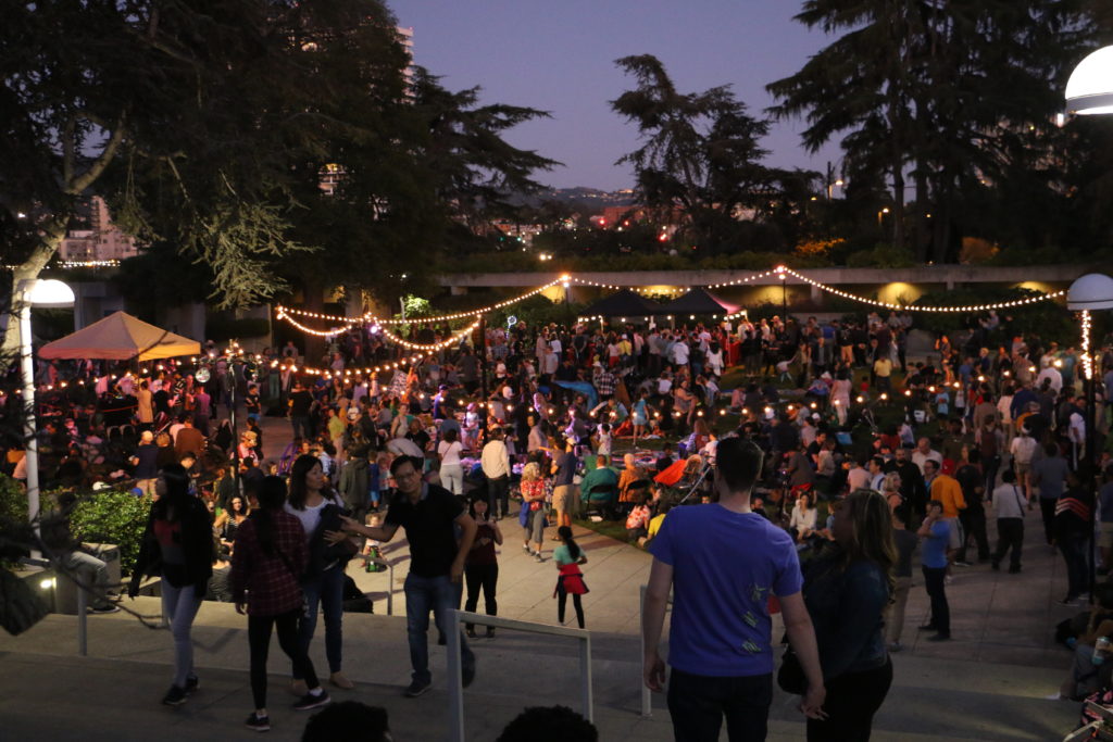 A crowd gathers over food and live music in OMCA's courtyard to celebrate its 50th anniversary. Photo by Hannah Ricker