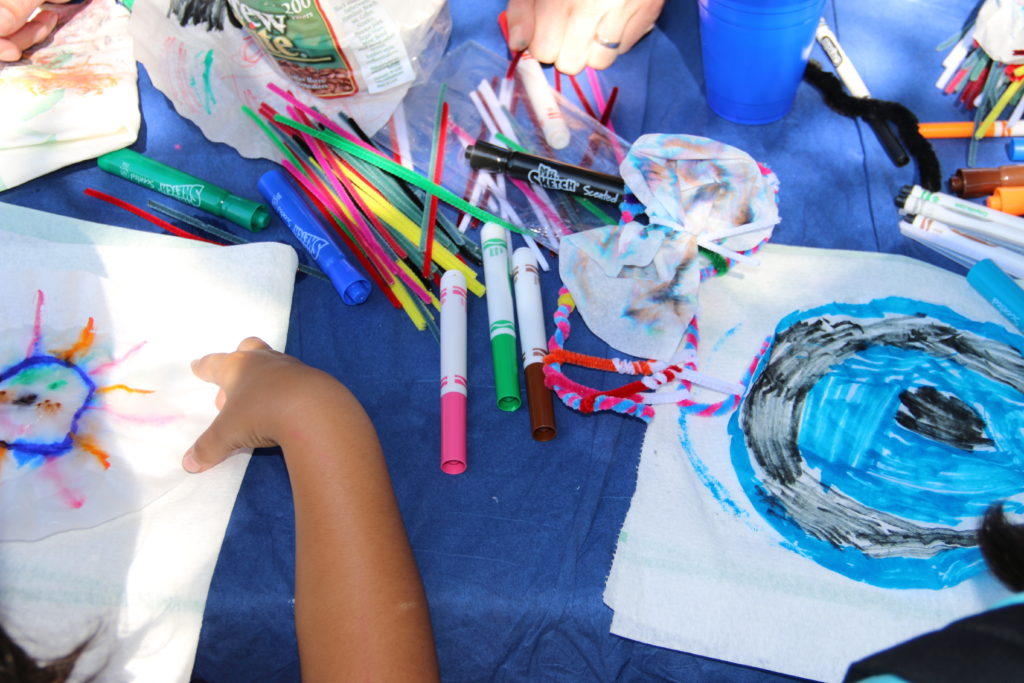 Children color and paint with bright colors on paper and coffee filters. Photo by Photo by Caroline Hart
