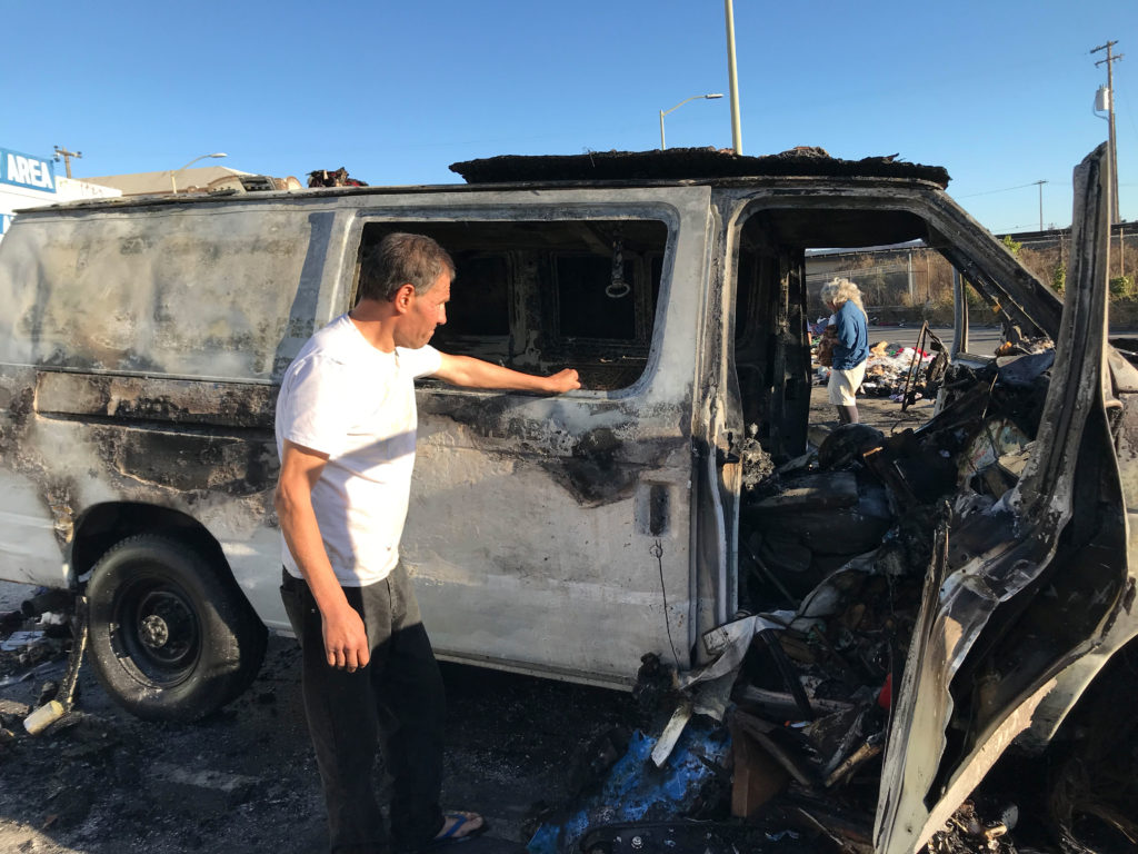 Haroutioun Manoukian looks at the remains of his burnt-out van, where he was living before the fire. Photo by Julia Kane.