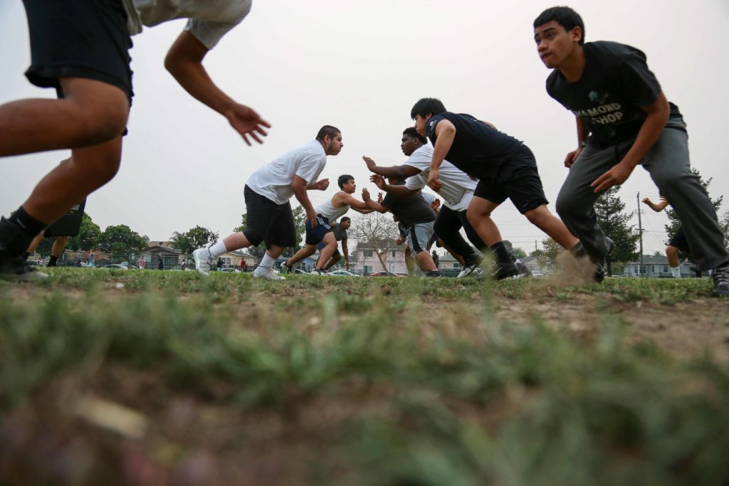 Castlemont offensive and defensive lines run a play at an October 1 practice