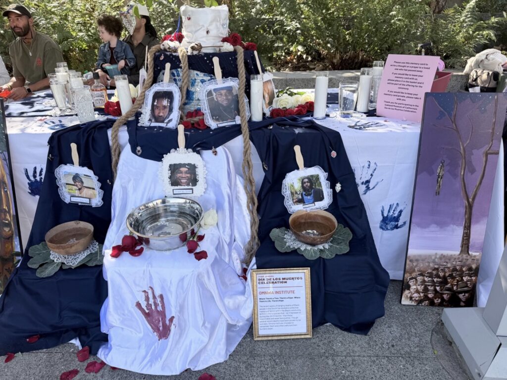 An altar, covered with dark blue and white cloth, on which placed six photos and seven candles.